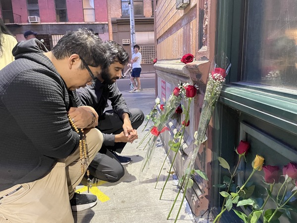 Vigil participants pray outside PP 1